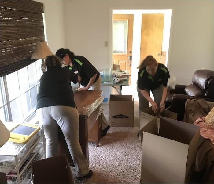 SERVPRO employees packing up fire damaged furniture