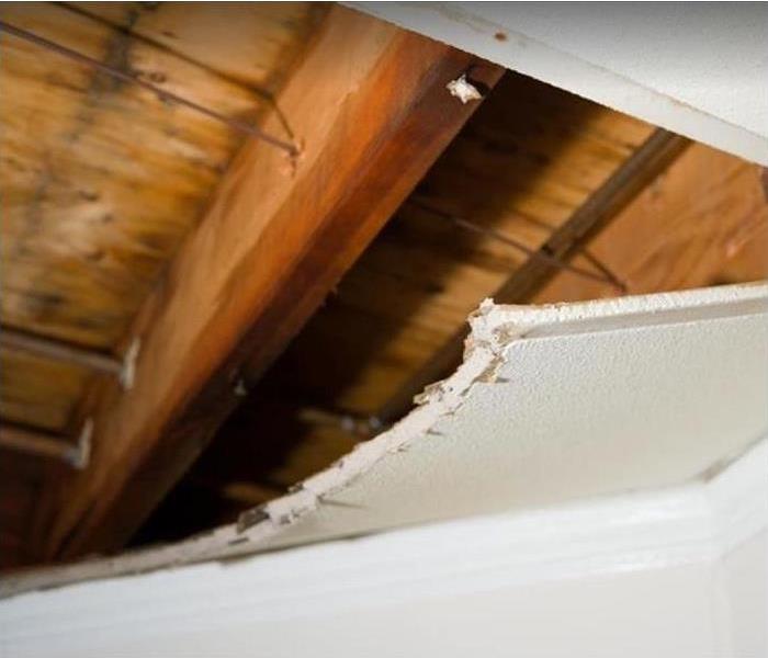water damaged ceiling; damaged drywall cut away