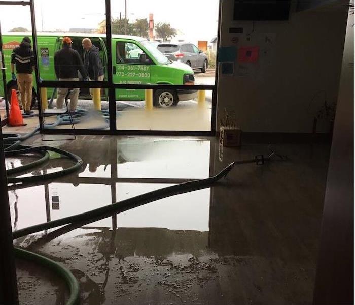 Office space with water damage and a SERVPRO van outside